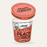 Secret Creamery Peach Cobbler 16 oz pint — super premium ice cream — lid off